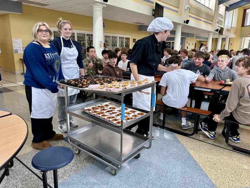 Cape High culinary students (l-r) Sarah Wolansky, Stella Farrell and Ayden Willis pass out food samples to classmates.